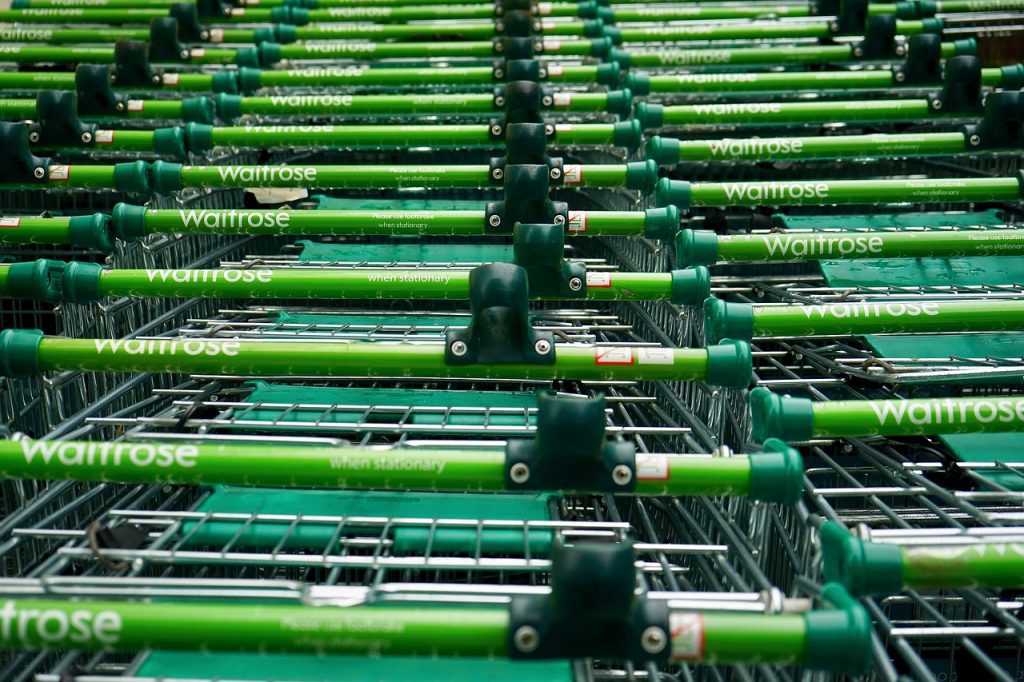 A line of Waitrose supermarket trolleys